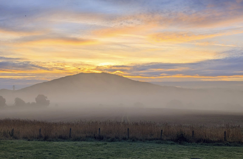 Sunrise over the Wrekin, with mist across the fields