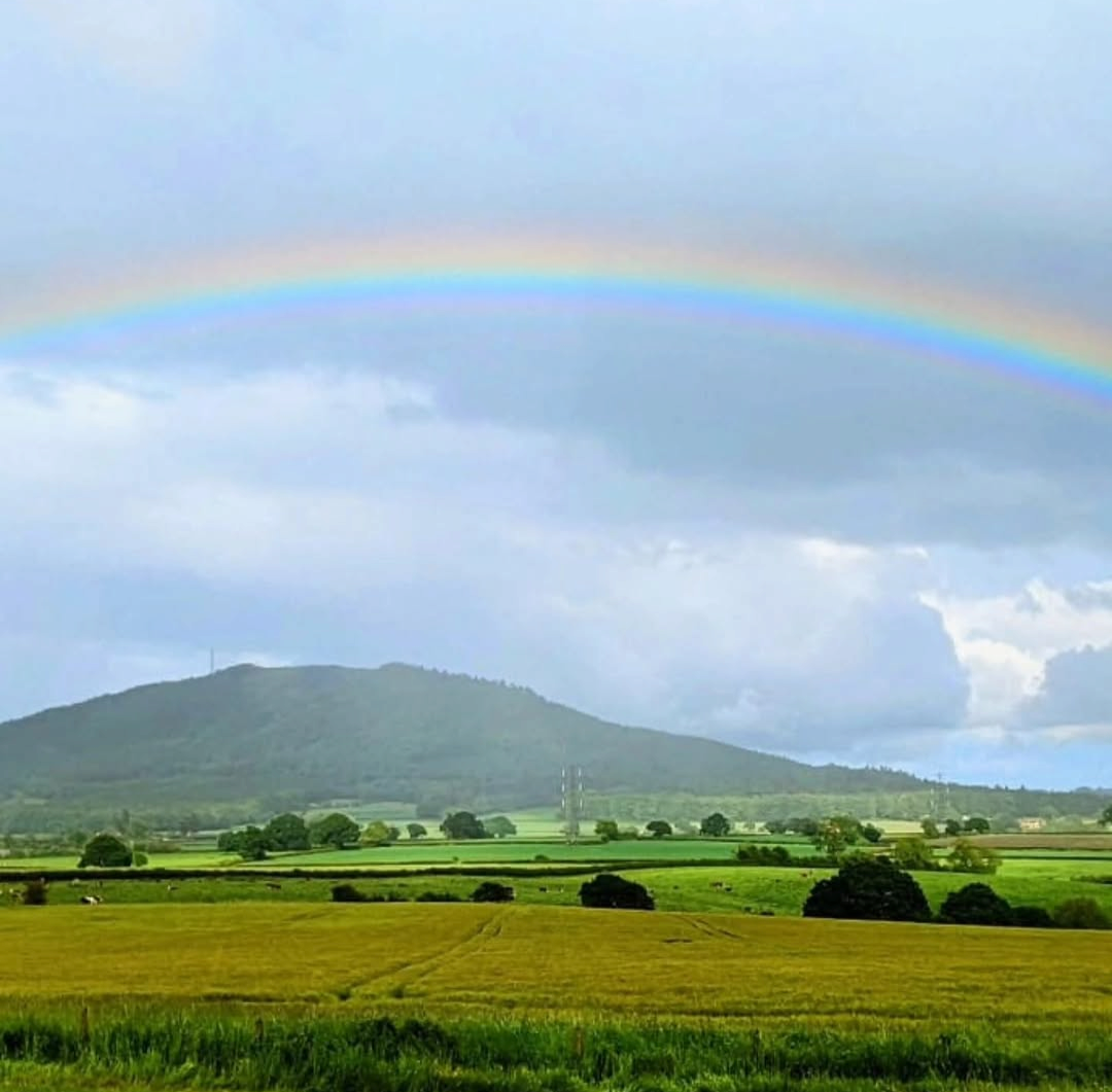 A rainbow over countryside hills near the Wrekin